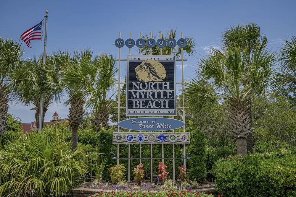 Welcome to the City of North Myrtle Beach sign surrounded by palm trees
